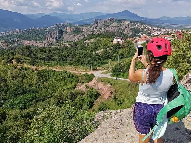 Woman taking photo of Belogradchik Rocks from high viewpoint
